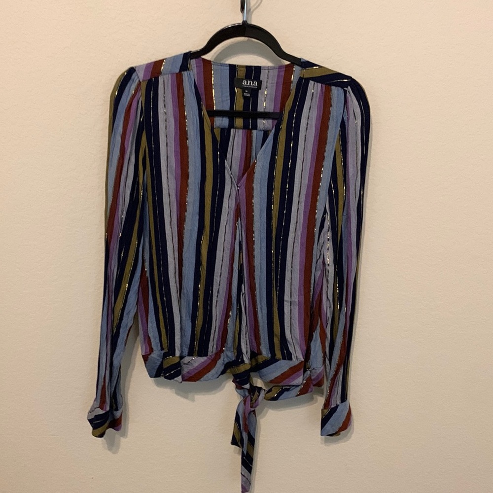 Cute wrap blouse with shiny detail woven throughout. Fun for work or weekend.